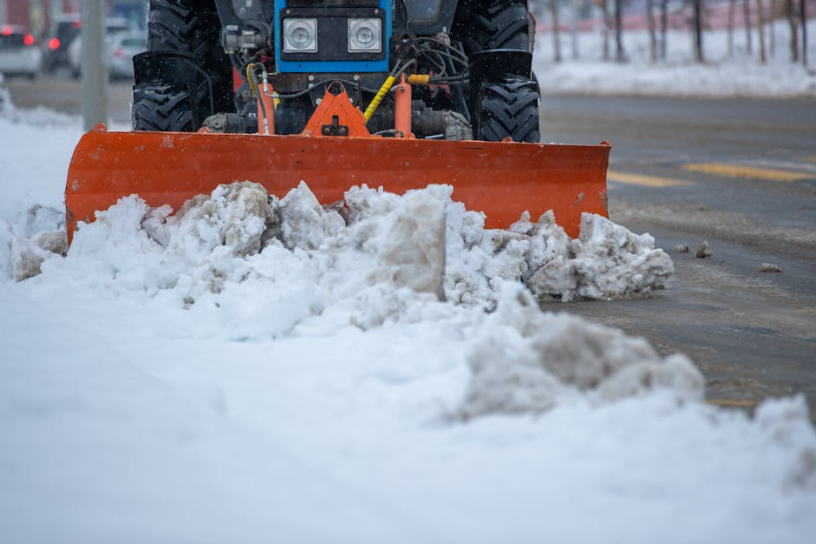 Tractor performing emergency snow removal to meet 60-minute response times and 2026 rate structures. Tractor performing emergency snow removal to meet 60-minute response times and 2026 rate structures.
